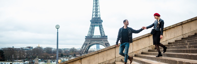 Couple walking down stairs with Eiffel Tower in the background