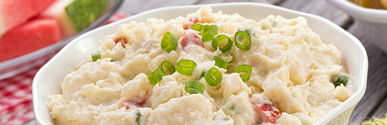 A bowl of potato salad on a table