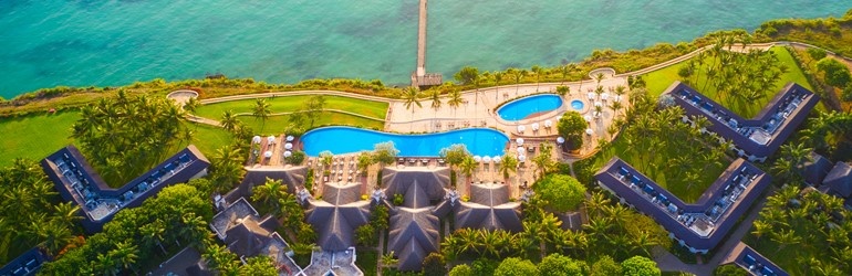 View of a hotel over looking a beach from above