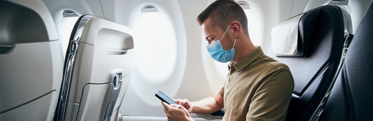 Man wearing a mask on the plane 